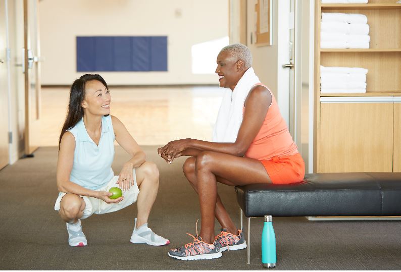 friends chatting after workout at a gym