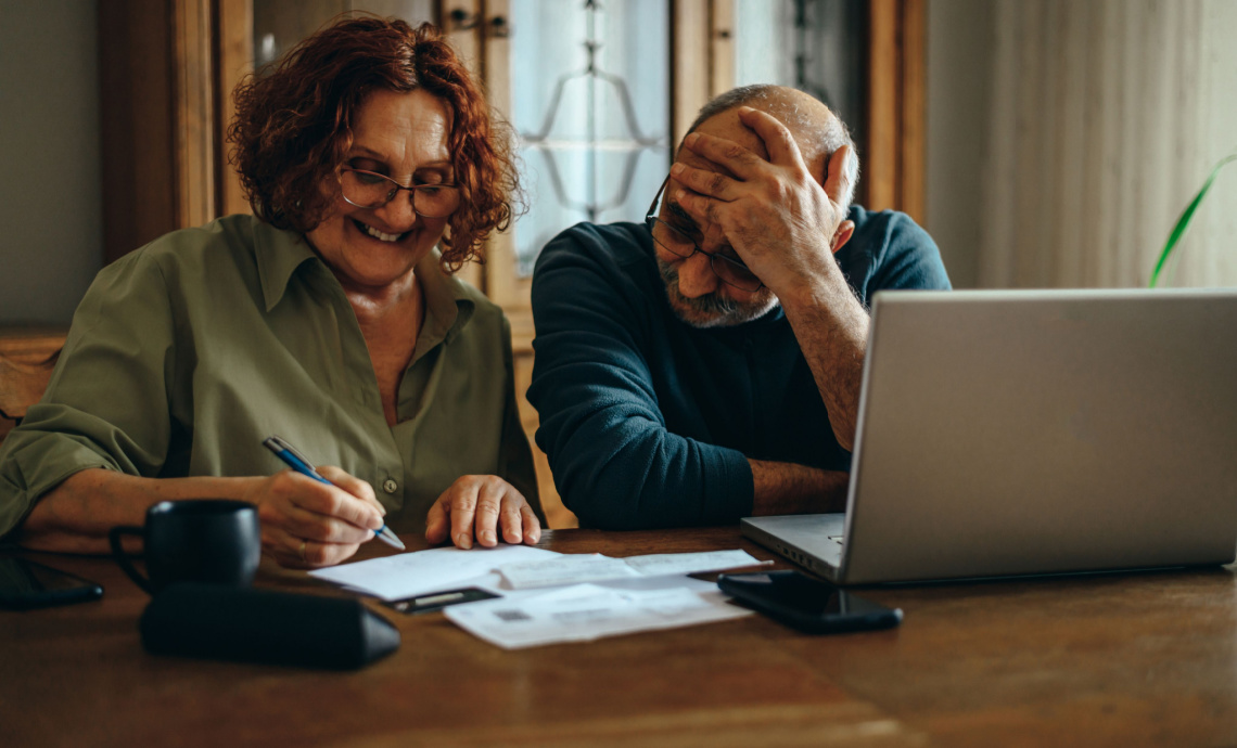 Couple working on their retirement plan at the dining room table