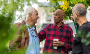 Three neighbours chatting with one another