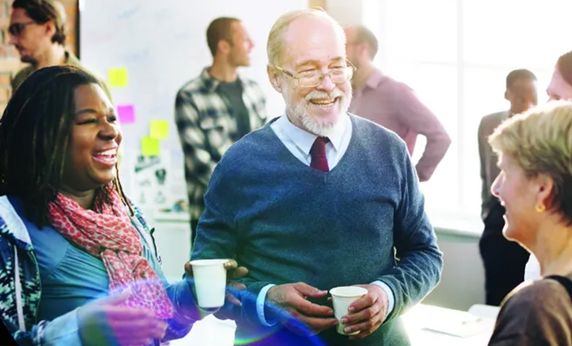 Conference attendees discussing the future of aging at RTOERO event