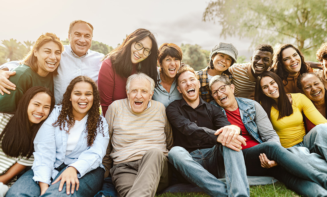 Multigenerational family members posing for a photo together in a group outside
